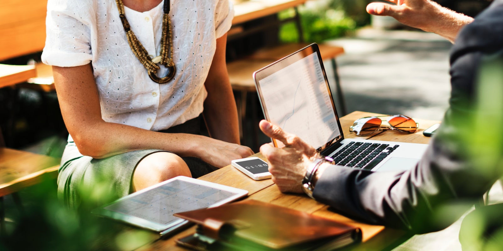 Two coworkers creating a marketing plan on a laptop.
